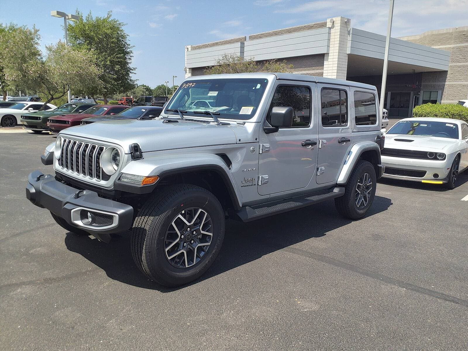 2019 Jeep Wrangler Unlimited Sahara, front three-quarter on a dealer lot
